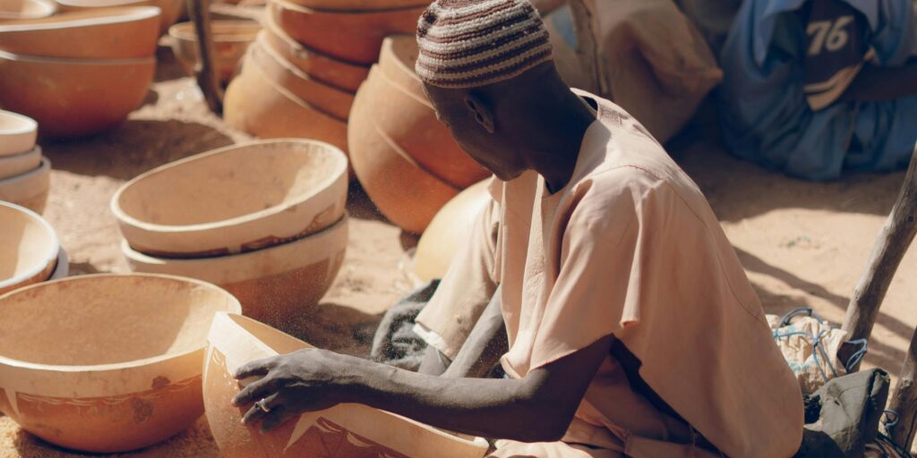 Image of an artisan building calabashes.